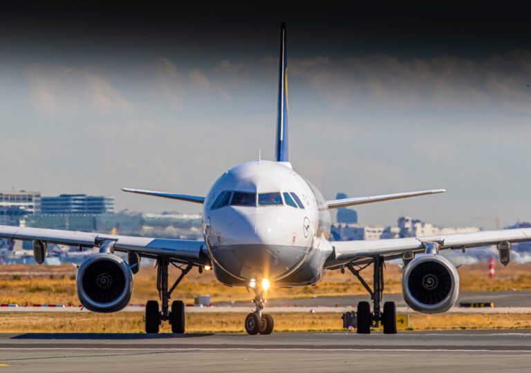 Front view of a commercial airliner taxiing on a runway