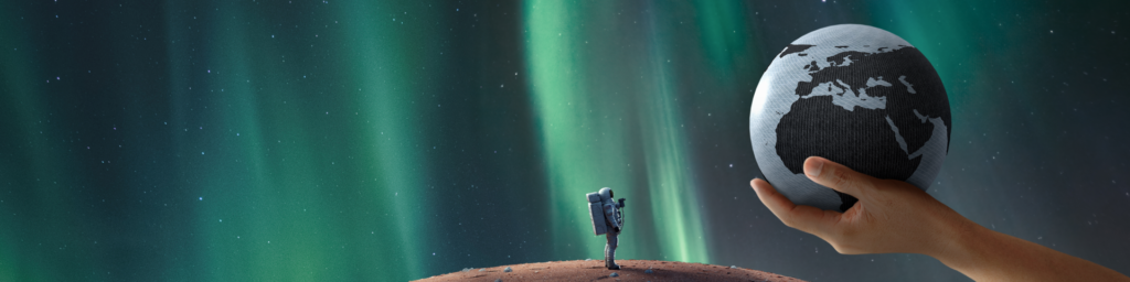 A hand holds a globe against a sky filled with the Northern Lights, while a small astronaut figure stands on a rocky surface.